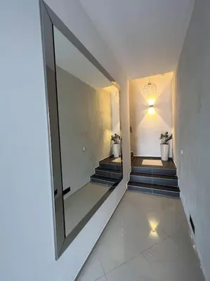 a hallway with stairs and a mirror on the wall at Salt INN Apartments No 1 in Wieliczka