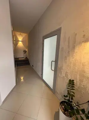 a hallway with a door and a potted plant at Salt INN Apartments No 1 in Wieliczka