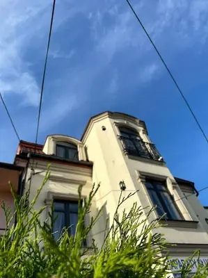 a tall white building with windows on top of it at Salt INN Apartments No 1 in Wieliczka