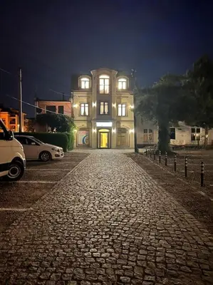 a large building with lights on in a street at Salt INN Apartments No 1 in Wieliczka