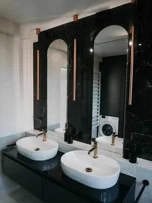 a bathroom with two sinks and two mirrors at Penthouse Słoneczna Rapsodia - blisko Parku Zdrojowego - duży taras na dachu - piękny widok - winda - garaż in Rabka