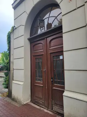 a wooden door on the side of a building at Grzegorzecka Room nr 5 in Kraków