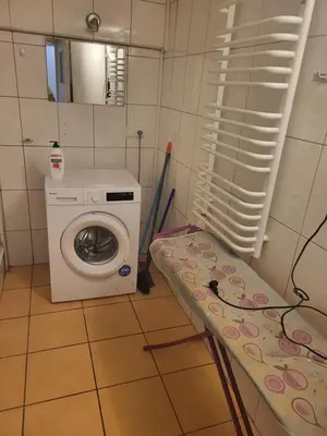 a laundry room with a washing machine and a washer at Grzegorzecka Room nr 5 in Kraków