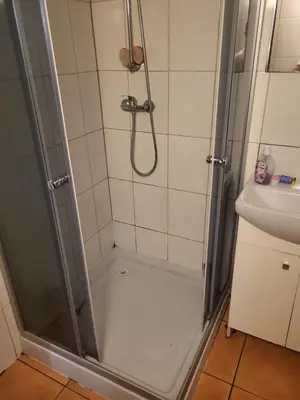 a bathroom with a shower and a sink at Grzegorzecka Room nr 5 in Kraków