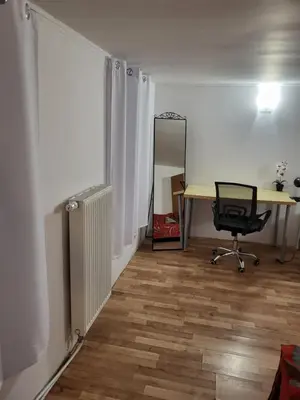 an office with a desk and a chair in a room at Grzegorzecka Room nr 5 in Kraków