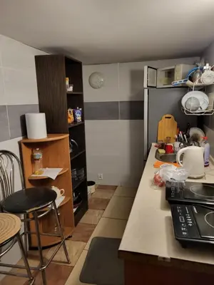 a small kitchen with a table and a counter top at Grzegorzecka Room nr 5 in Kraków