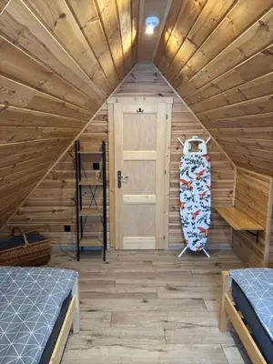a room with two beds and a door at Domki na granicy - Kocoń in Jeżowski Dział
