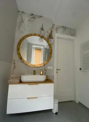 a bathroom with a white sink and a mirror at Comfort Garden View Apartment in Kraków