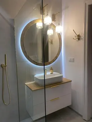 a bathroom with a sink and a mirror at Comfort Garden View Apartment in Kraków