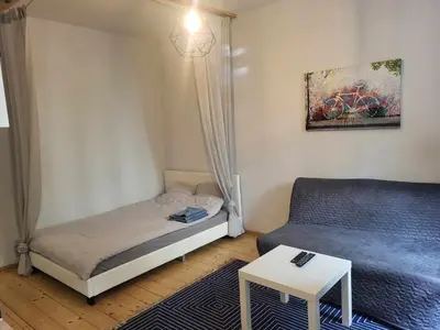 a small bedroom with a bed and a couch at ViP Apartment Krakow in Kraków