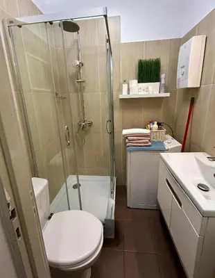 a bathroom with a shower and a toilet and a sink at ViP Apartment Krakow in Kraków