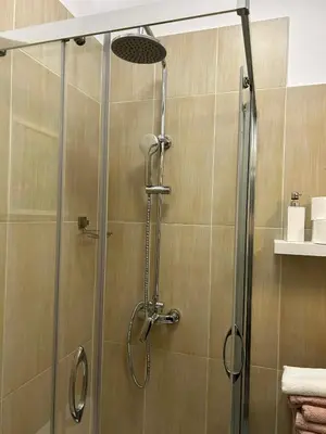 a shower with a glass door in a bathroom at ViP Apartment Krakow in Kraków