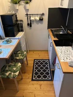 a kitchen with a stove and a table with chairs at ViP Apartment Krakow in Kraków