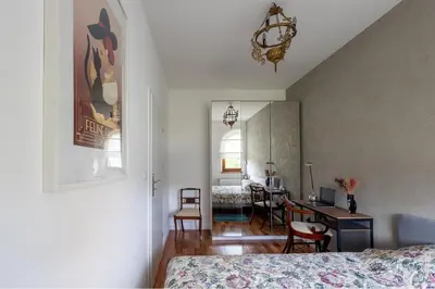 a bedroom with a bed and a desk with a computer at Zakątek Apartments in Kraków