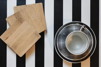 a coffee cup and a fan on a table at Zakątek Apartments in Kraków