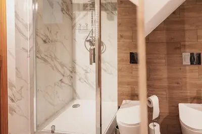 a bathroom with a shower and a toilet at Zakątek Apartments in Kraków