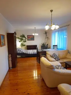 a living room with a couch and a dining room at Bronowice- parter domu in Kraków