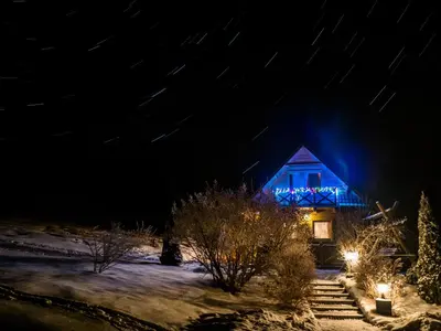a house with blue lights on it at night at Domek w górach in Nowy Targ