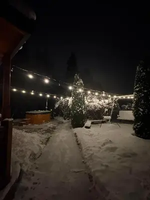 a log cabin in the snow at night at Domek w górach in Nowy Targ