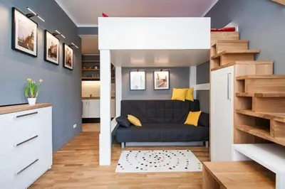 a bedroom with a large bed with a wooden headboard at Zulu Apartments Old Town in Kraków