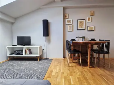 a kitchen with wooden cabinets and a sink at Zulu Apartments Old Town in Kraków