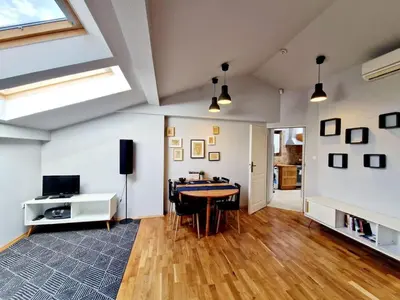 a bedroom with a large bed with two shoes on it at Zulu Apartments Old Town in Kraków
