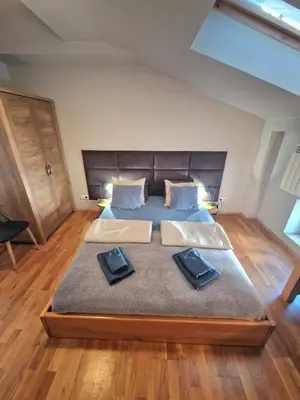 a dining room with a wooden table and chairs at Zulu Apartments Old Town in Kraków