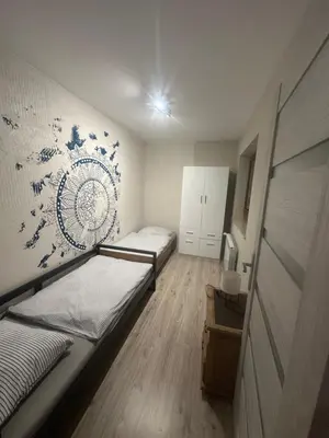 a small room with two beds and a wall at Domek w Koszarawie Bystrej in Koszarawa