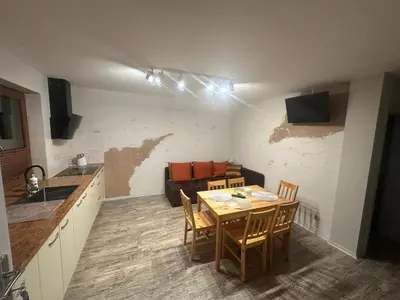 a kitchen and dining room with a table and chairs at Domek w Koszarawie Bystrej in Koszarawa
