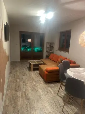 a living room with a couch and a table at Domek w Koszarawie Bystrej in Koszarawa