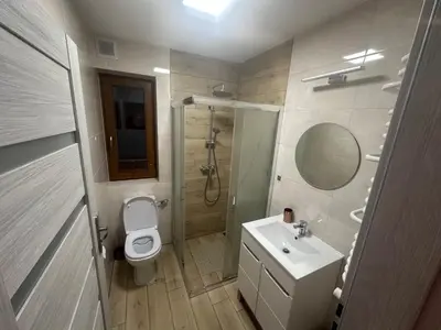 a bathroom with a toilet and a sink and a shower at Domek w Koszarawie Bystrej in Koszarawa