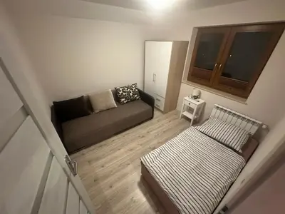 a small living room with a couch and a window at Domek w Koszarawie Bystrej in Koszarawa
