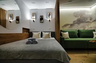 a bedroom with a bed and a green couch at Good rest in 52 in Zator