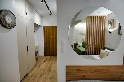 a room with a round mirror and a living room at Good rest in 52 in Zator
