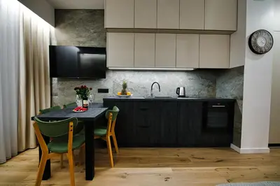 a kitchen with a table with chairs and a sink at Good rest in 52 in Zator