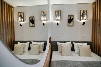 two beds in a room with a mirror at Good rest in 52 in Zator