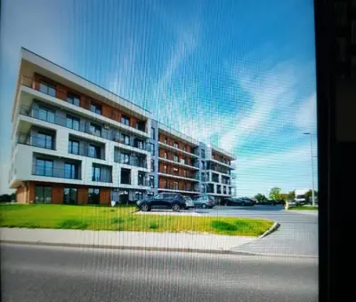 a car parked in front of a large building at Good rest in 52 in Zator