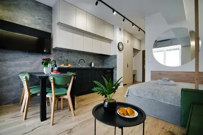 a bedroom and a living room with a bed and a table at Good rest in 52 in Zator