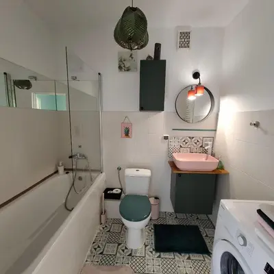 a bathroom with a toilet and a sink at Apartament Pastelowy in Kraków