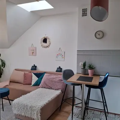 a living room with a couch and a table at Apartament Pastelowy in Kraków
