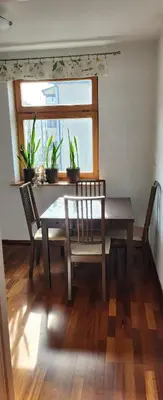 a dining room with a table and two chairs and a window at Nature in Kraków
