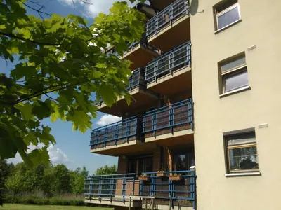 a building with balconies on the side of it at Nature in Kraków