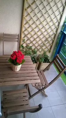 a wooden table with two potted plants and a bench at Nature in Kraków