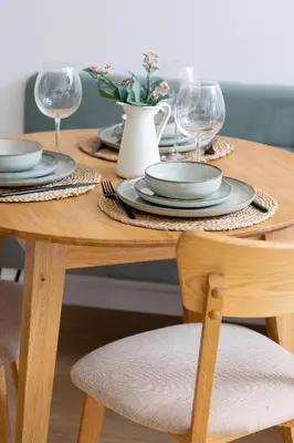 a wooden table with plates and wine glasses on it at Unique Air-conditioned Apartment Dietla Cracow by Noclegi Renters in Kraków