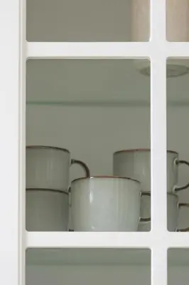 a shelf filled with white pots and pans at Unique Air-conditioned Apartment Dietla Cracow by Noclegi Renters in Kraków