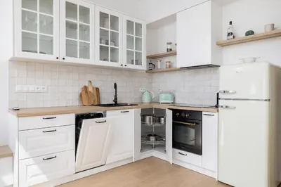 a white kitchen with white cabinets and appliances at Unique Air-conditioned Apartment Dietla Cracow by Noclegi Renters in Kraków