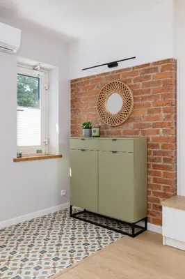a kitchen with a brick wall and a mirror at Unique Air-conditioned Apartment Dietla Cracow by Noclegi Renters in Kraków