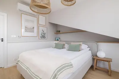 a bedroom with a large white bed with green pillows at Unique Air-conditioned Apartment Dietla Cracow by Noclegi Renters in Kraków