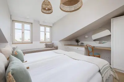 a white bedroom with a large bed and two windows at Unique Air-conditioned Apartment Dietla Cracow by Noclegi Renters in Kraków