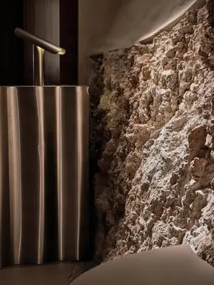 a metal trash can next to a stone wall at Zinar Castle in Kraków